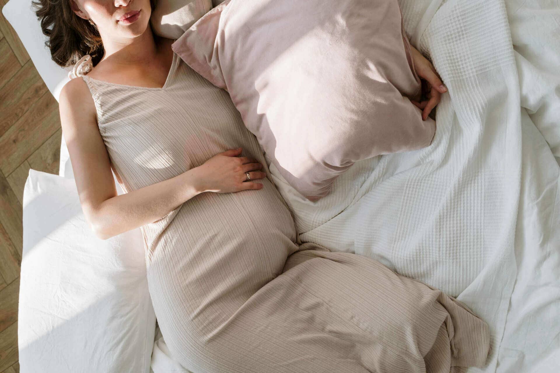 pregnant woman in bed with morning sickness